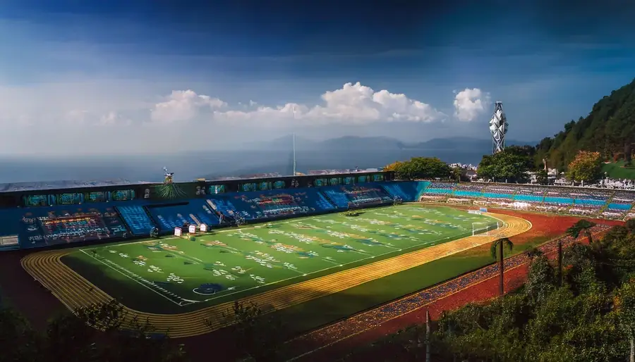 Sunlit stadium with mountains behind